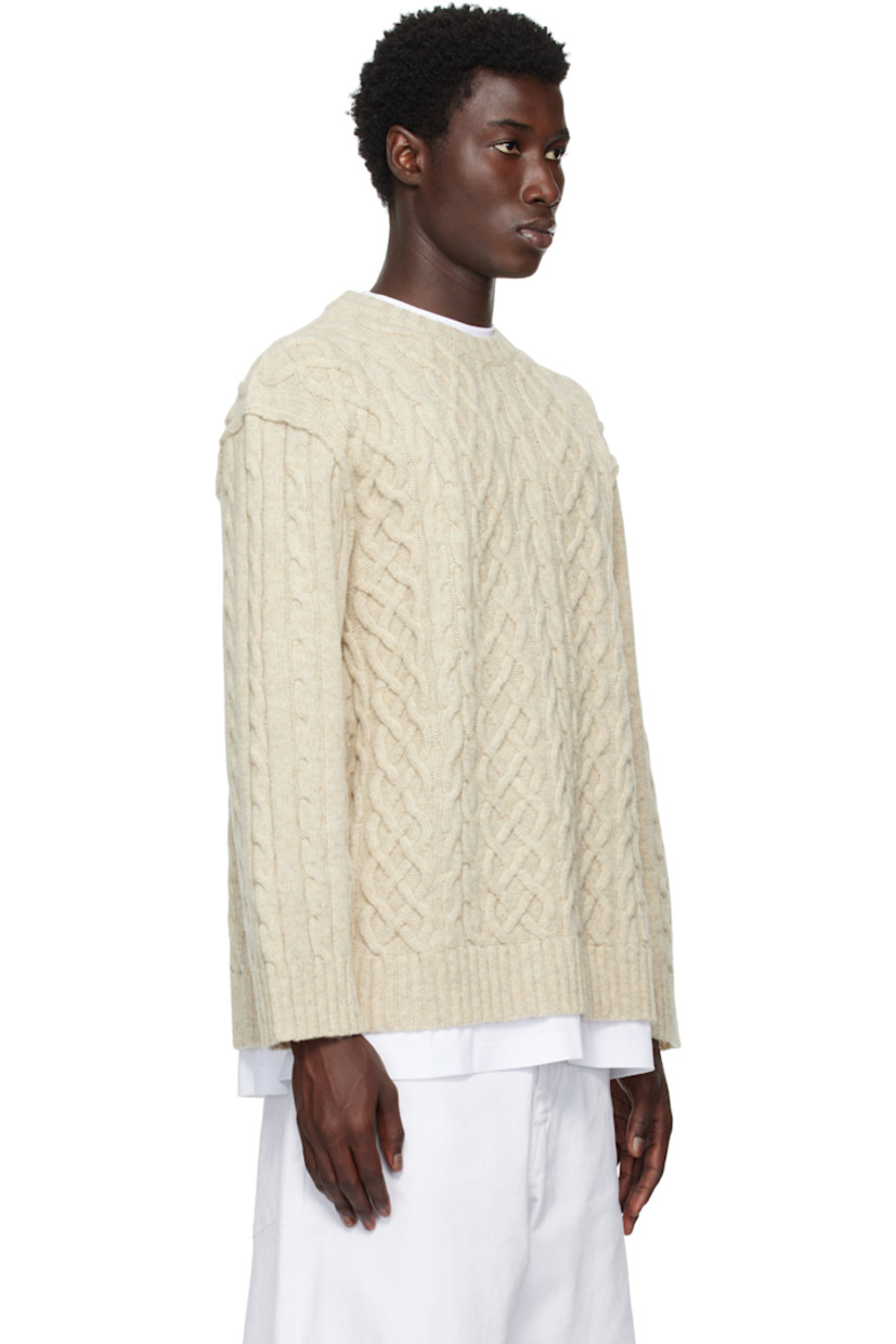 Cable-knit virgin wool sweater.

· Rib-knit crewneck, hem, and cuffs
· Dropped shoulders
· Full jersey lining
· Logo embroidered at back

Supplier color: Ivory