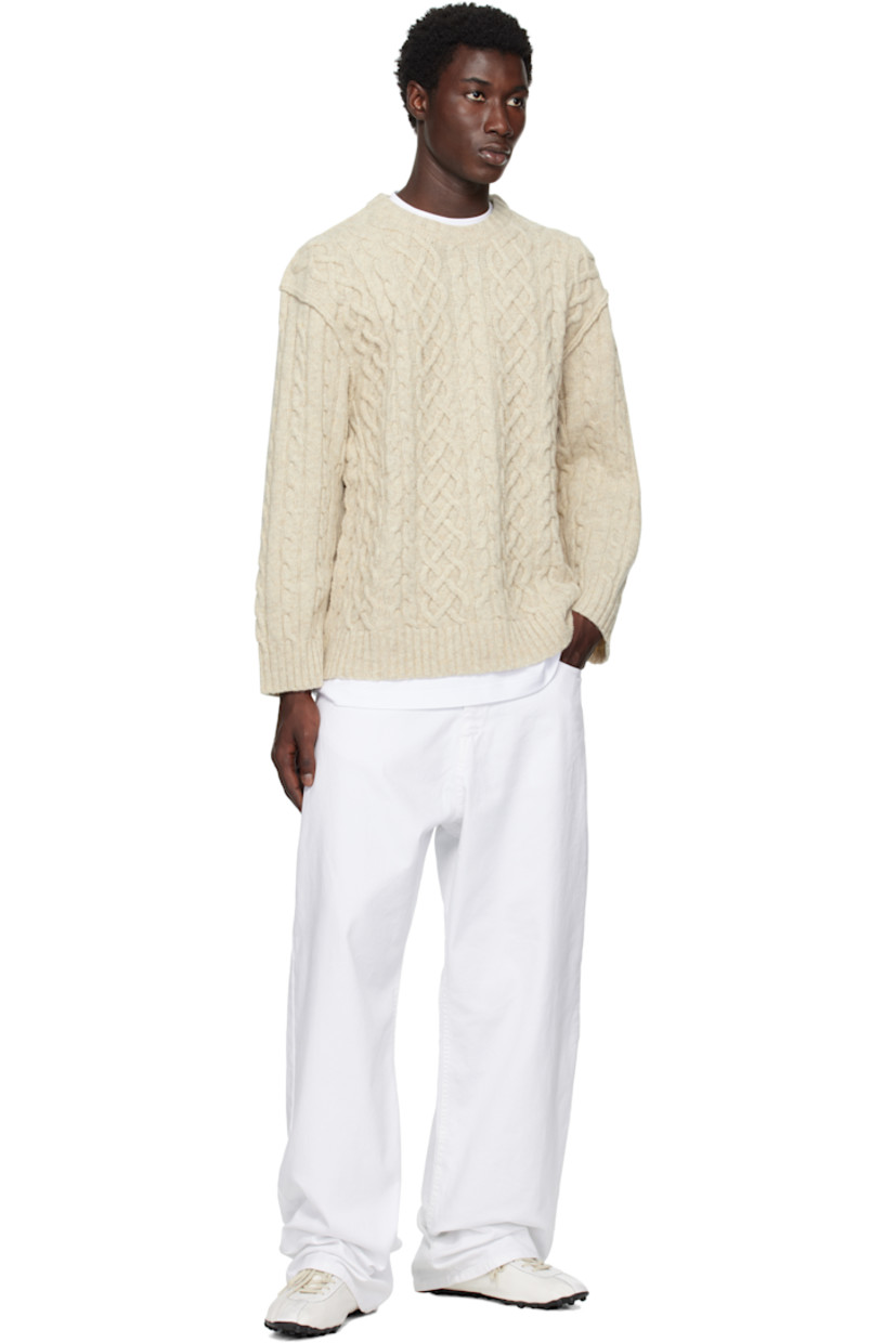 Cable-knit virgin wool sweater.

· Rib-knit crewneck, hem, and cuffs
· Dropped shoulders
· Full jersey lining
· Logo embroidered at back

Supplier color: Ivory