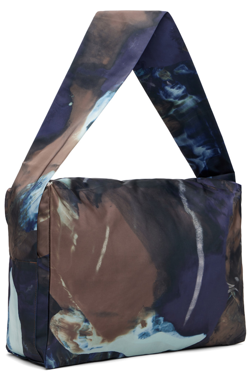 Satin messenger bag.

· Graphic pattern printed throughout 
· Integrated crossbody strap
· Zip pocket at face
· Two-way zip closure
· H11.5" x W15" x D5"

Supplier color: Brown