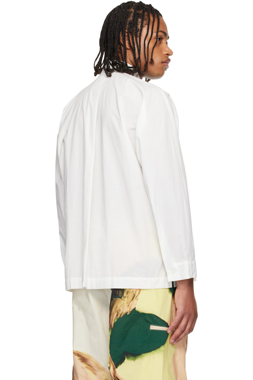 Semi-sheer crinkled organic cotton poplin shirt. 

· Band collar 
· Button closure 
· Patch pocket at chest
· Vented side seams
· Buttoned barrel cuffs
· Box pleat at back yoke 

Supplier color: White