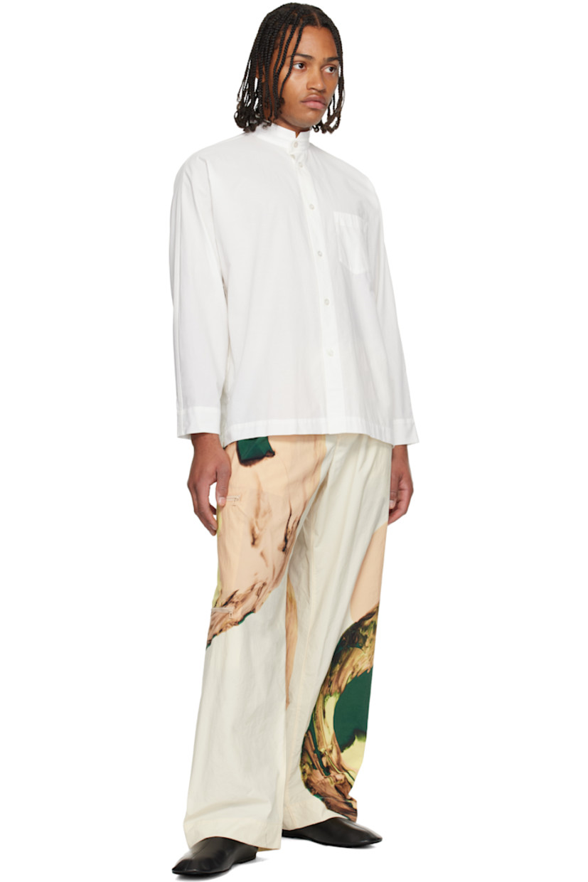 Semi-sheer crinkled organic cotton poplin shirt. 

· Band collar 
· Button closure 
· Patch pocket at chest
· Vented side seams
· Buttoned barrel cuffs
· Box pleat at back yoke 

Supplier color: White