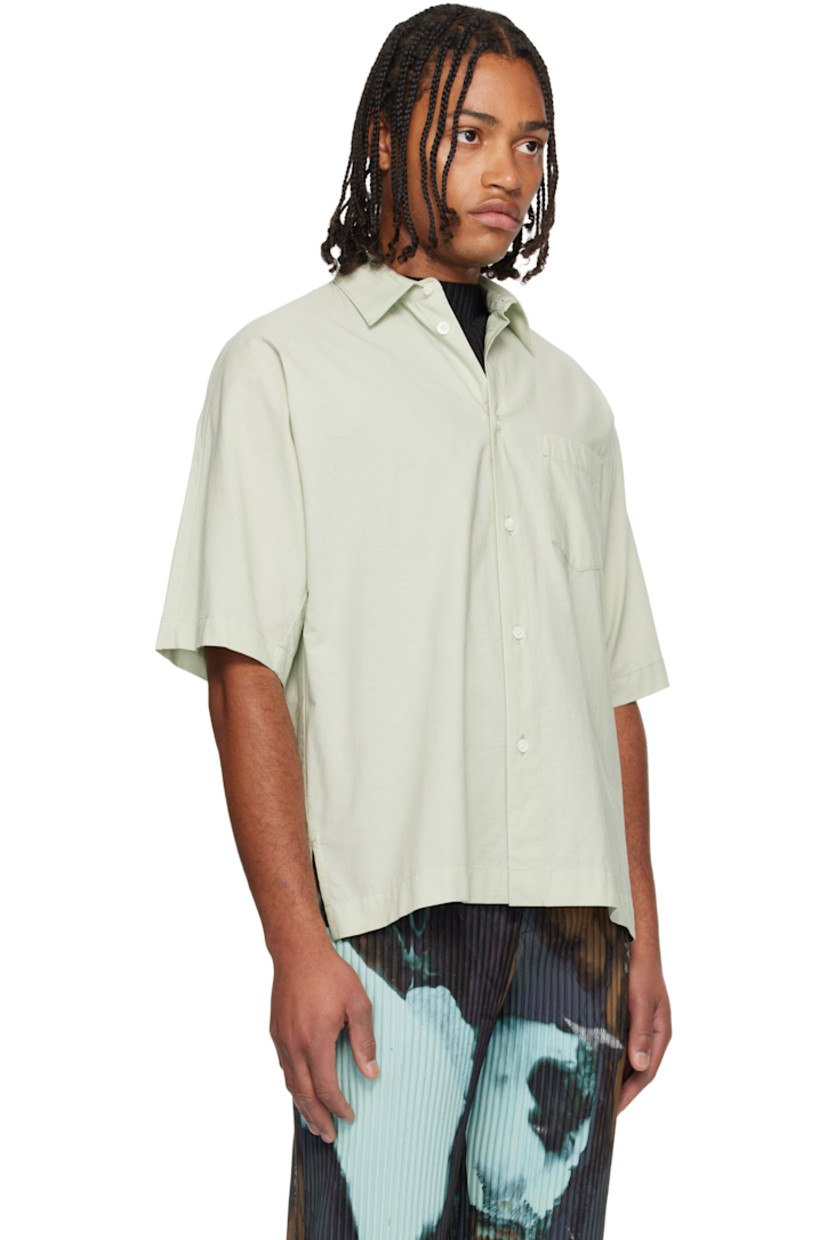 Semi-sheer crinkled organic cotton poplin shirt. 

· Spread collar 
· Button closure 
· Patch pocket at chest
· Vented side seams
· Box pleat at back yoke 

Supplier color: White green