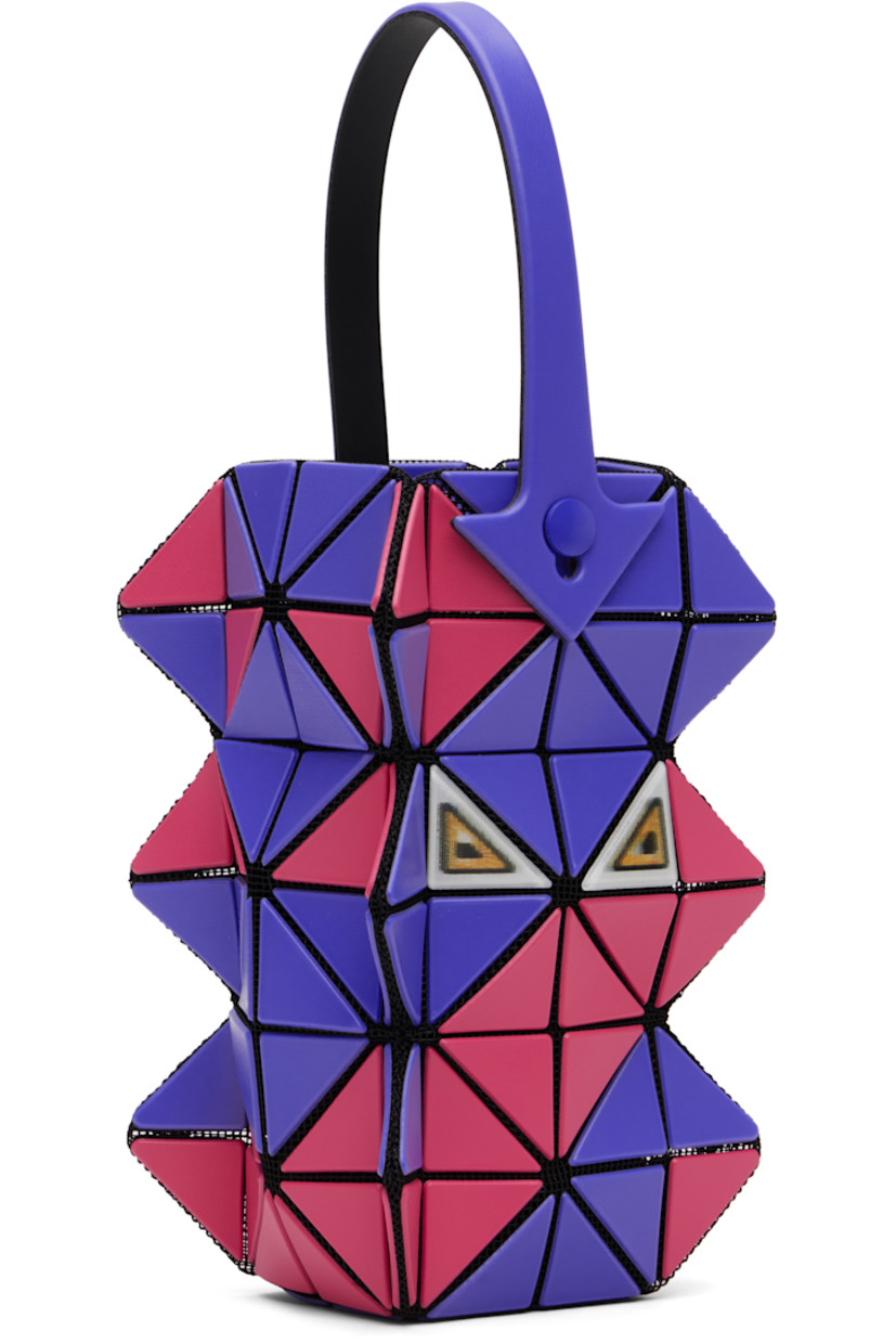 Sculptural mesh top handle bag.

· Signature triangular vinyl appliqués in blue and red throughout
· Fixed carry handle
· Lenticular graphic appliqués at face and back face
· Logo-woven canvas lining
· H6" x W3.5" x D2"

Supplier color: Blue /Red