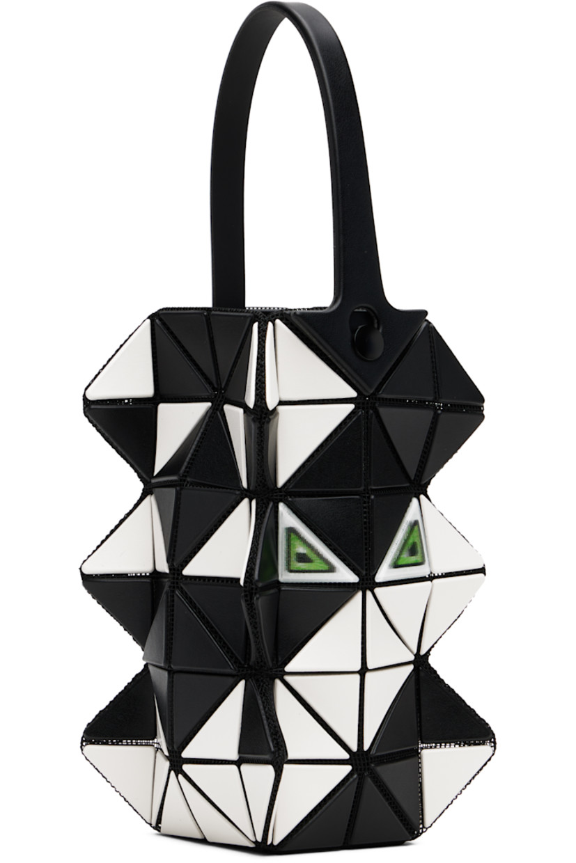 Sculptural mesh top handle bag.

· Signature triangular vinyl appliqués in black and off-white throughout
· Fixed carry handle
· Lenticular graphic appliqués at face and back face
· Logo-woven canvas lining
· H6" x W3.5" x D2"

Supplier color: Black/Off white