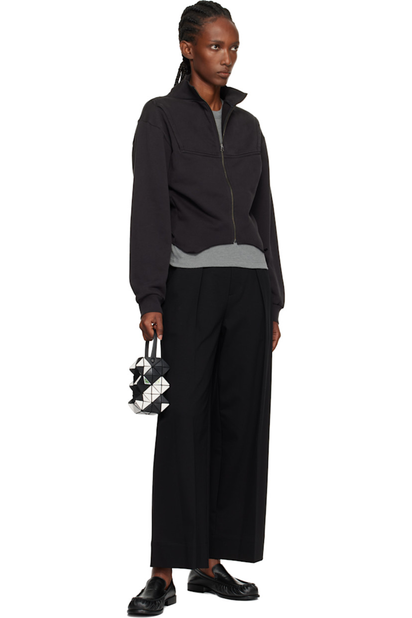 Sculptural mesh top handle bag.

· Signature triangular vinyl appliqués in black and off-white throughout
· Fixed carry handle
· Lenticular graphic appliqués at face and back face
· Logo-woven canvas lining
· H6" x W3.5" x D2"

Supplier color: Black/Off white