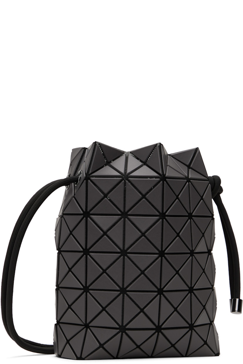 Mesh shoulder bag in black. 

· Triangular faux-leather appliqués in gray throughout
· Adjustable drawstring shoulder strap
· Open throat
· Zip pocket at interior
· Patterned textile lining
· H9" x W8" x D3.5"

Supplier color: Charcoal