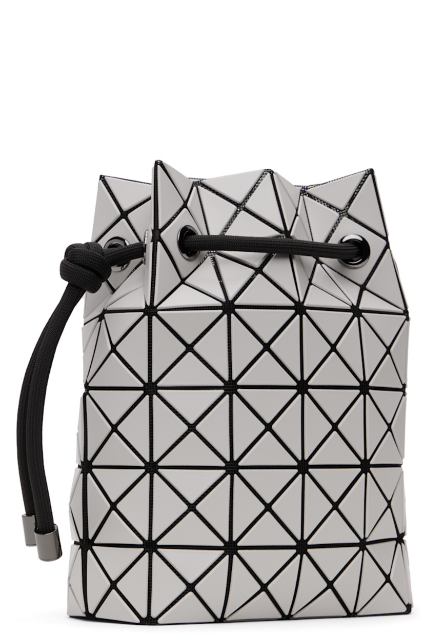 Mesh shoulder bag in black. 

· Triangular faux-leather appliqués in off-white throughout
· Adjustable drawstring shoulder strap
· Open throat
· Zip pocket at interior
· Patterned textile lining
· H9" x W8" x D3.5"

Supplier color: Light gray