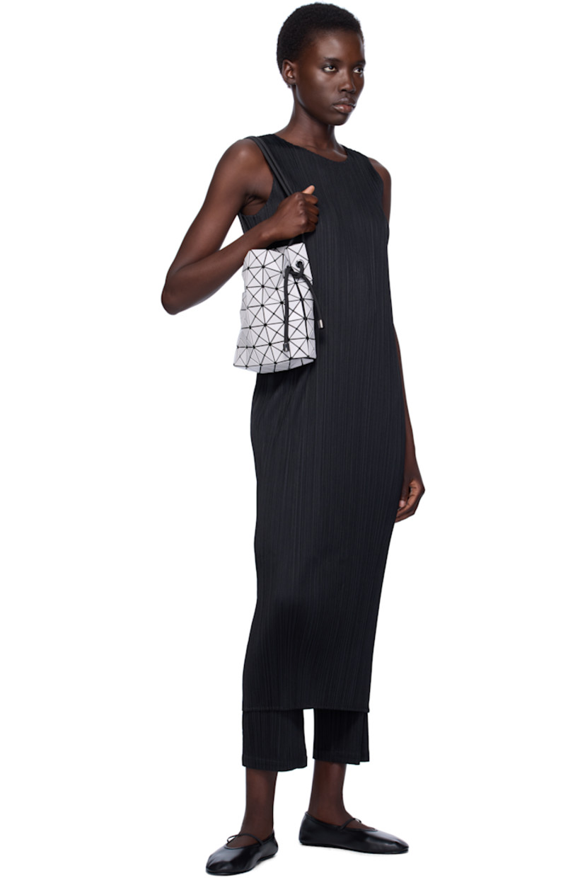 Mesh shoulder bag in black. 

· Triangular faux-leather appliqués in off-white throughout
· Adjustable drawstring shoulder strap
· Open throat
· Zip pocket at interior
· Patterned textile lining
· H9" x W8" x D3.5"

Supplier color: Light gray