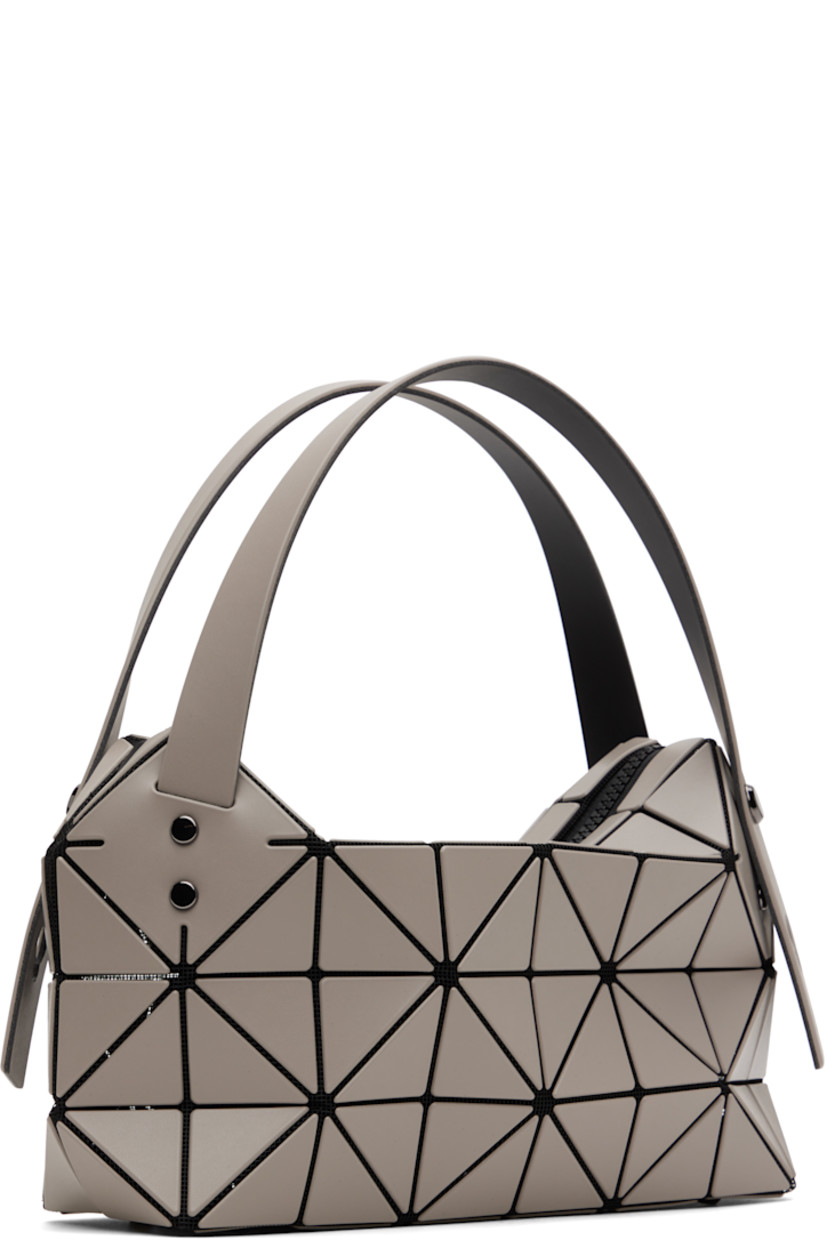 Mesh shoulder bag in black. 

· Signature triangular vinyl appliqués in gray throughout
· Adjustable shoulder straps
· Bumper studs at base
· Two-way zip closure
· Patch pocket at interior
· Logo-engraved gunmetal-tone hardware
· H6.5" x W10" x D3"
 
Supplier color: Greige