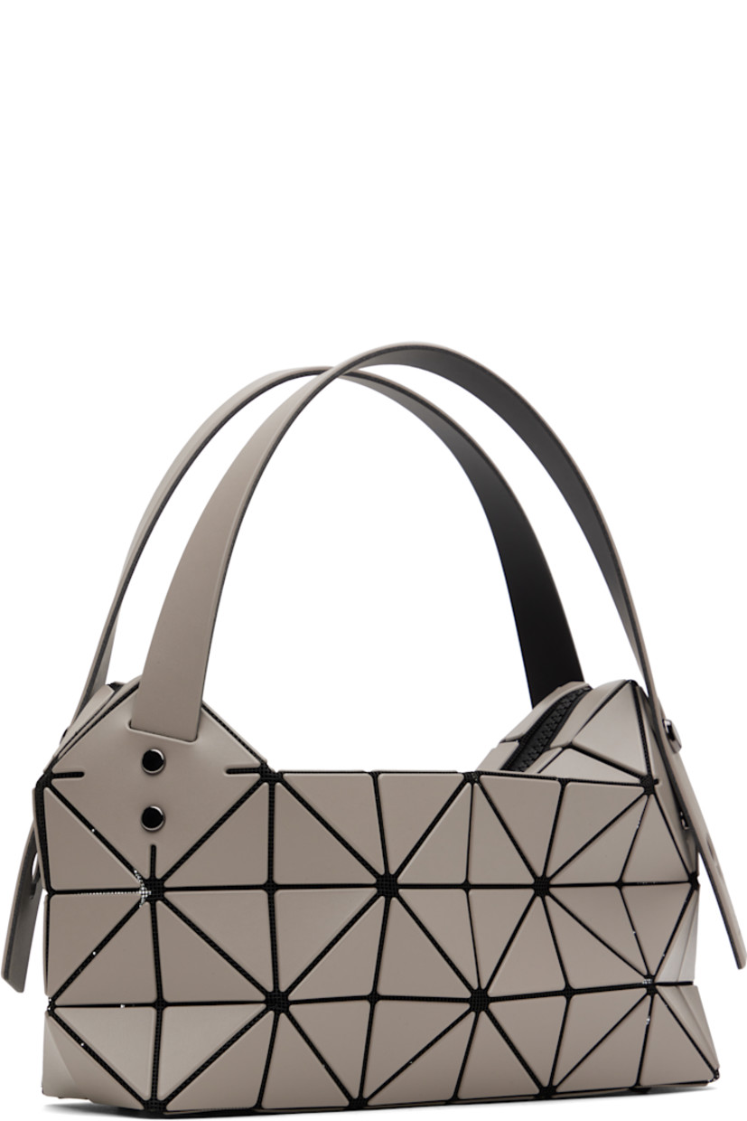 Mesh shoulder bag in black. 

· Signature triangular vinyl appliqués in gray throughout
· Adjustable shoulder straps
· Bumper studs at base
· Two-way zip closure
· Patch pocket at interior
· Logo-engraved gunmetal-tone hardware
· H6.5" x W10" x D3"
 
Supplier color: Greige