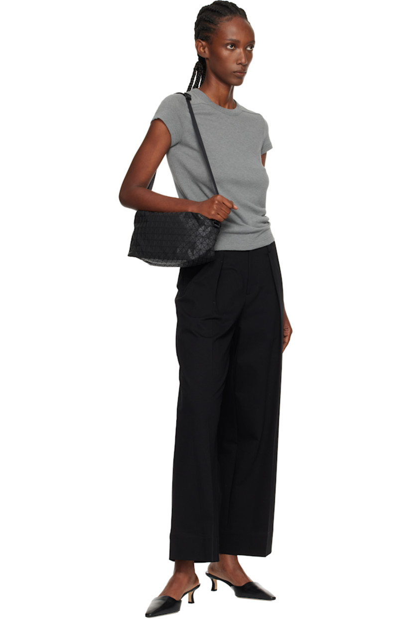Twill shoulder bag.

· Signature triangular vinyl appliqués throughout
· Adjustable crossbody strap
· Zip closure
· Zip pocket at interior
· H6" x W11.5" x D4.5"

Supplier color: Matte black
