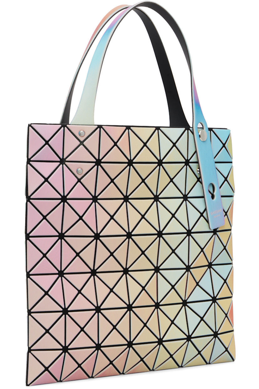 Mesh tote.

· Triangular iridescent vinyl appliqués throughout
· Adjustable shoulder straps
· Zip pocket at interior
· H11" x W11"

Supplier color: White base