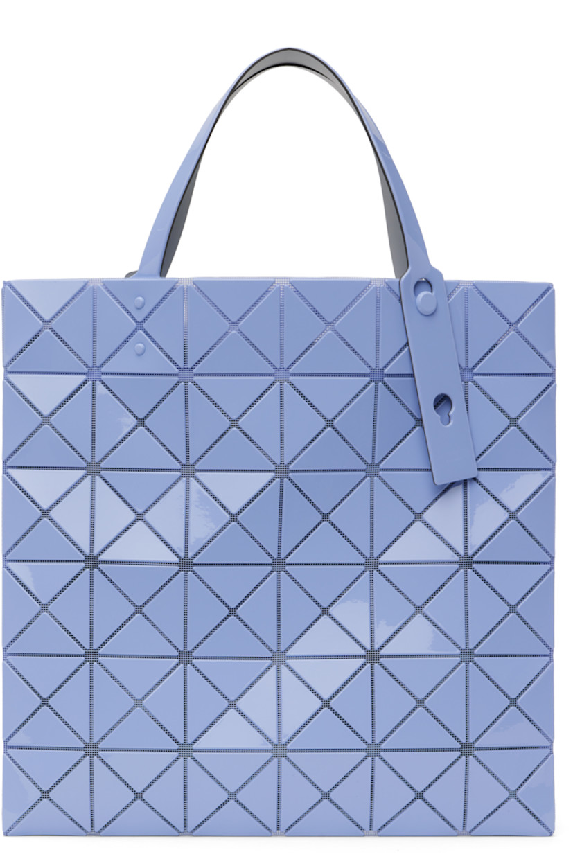 Sheer mesh tote in blue. 

· Triangular glossy polymer appliqués throughout
· Twin adjustable faux-leather carry handles
· Zip pocket at interior
· Unlined
· H13.5" x W13.5"

Supplier color: Light blue
