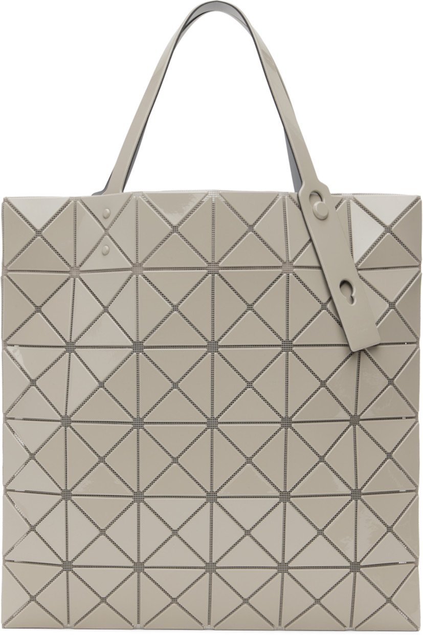Sheer mesh tote in beige.

· Triangular glossy polymer appliqués throughout
· Twin adjustable faux-leather carry handles
· Zip pocket at interior
· Unlined
· H13.5" x W13.5"

Supplier color: Sand beige