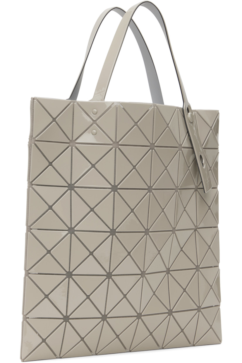 Sheer mesh tote in beige.

· Triangular glossy polymer appliqués throughout
· Twin adjustable faux-leather carry handles
· Zip pocket at interior
· Unlined
· H13.5" x W13.5"

Supplier color: Sand beige