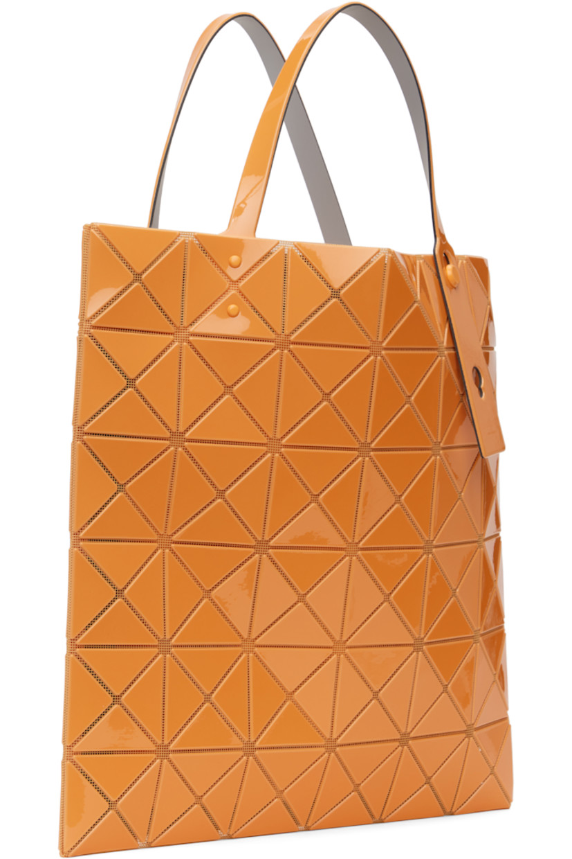 Sheer mesh tote in orange. 

· Triangular glossy polymer appliqués throughout
· Twin adjustable faux-leather carry handles
· Zip pocket at interior
· Unlined
· H13.5" x W13.5"

Supplier color: Orange