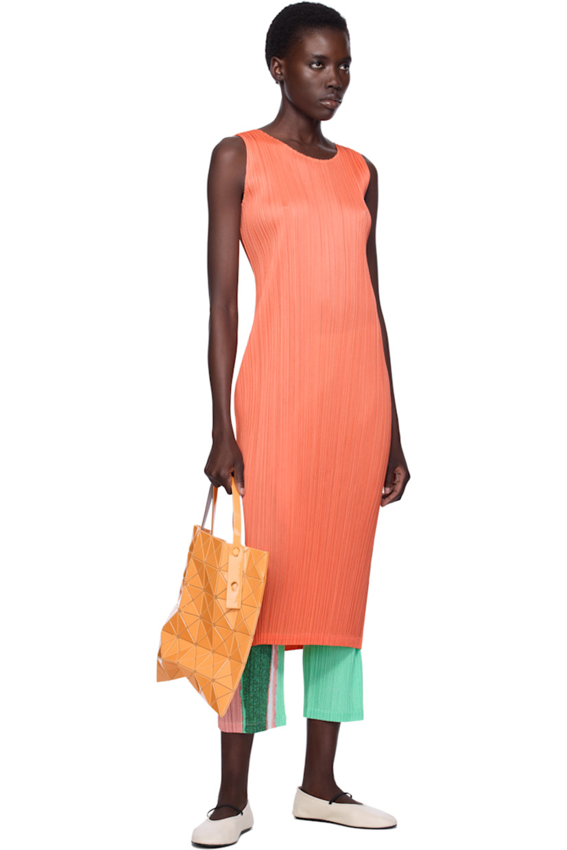 Sheer mesh tote in orange. 

· Triangular glossy polymer appliqués throughout
· Twin adjustable faux-leather carry handles
· Zip pocket at interior
· Unlined
· H13.5" x W13.5"

Supplier color: Orange