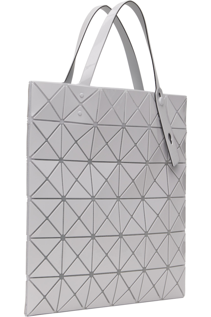 Sheer mesh tote in off-white. 

· Triangular glossy polymer appliqués throughout
· Twin adjustable faux-leather carry handles
· Zip pocket at interior
· Unlined
· H13.5" x W13.5"

Supplier color: Light gray