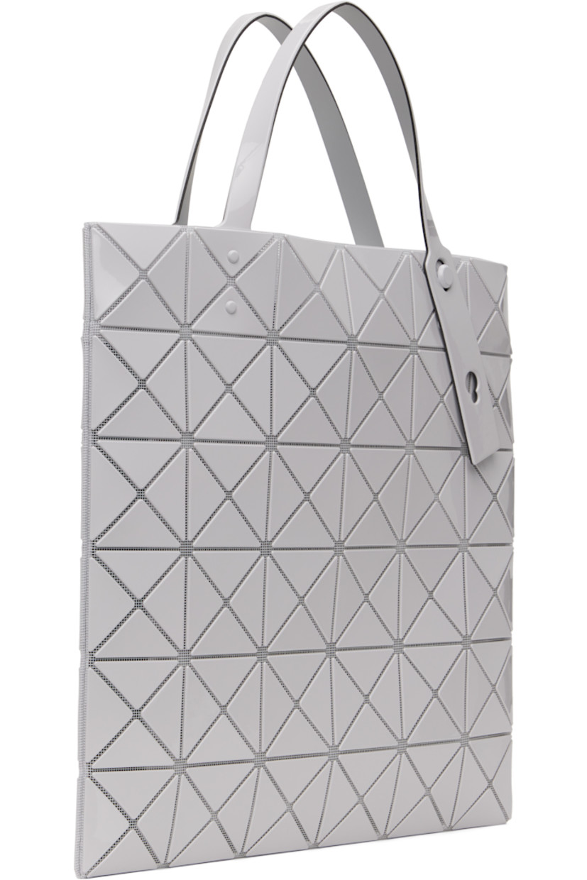 Sheer mesh tote in off-white. 

· Triangular glossy polymer appliqués throughout
· Twin adjustable faux-leather carry handles
· Zip pocket at interior
· Unlined
· H13.5" x W13.5"

Supplier color: Light gray