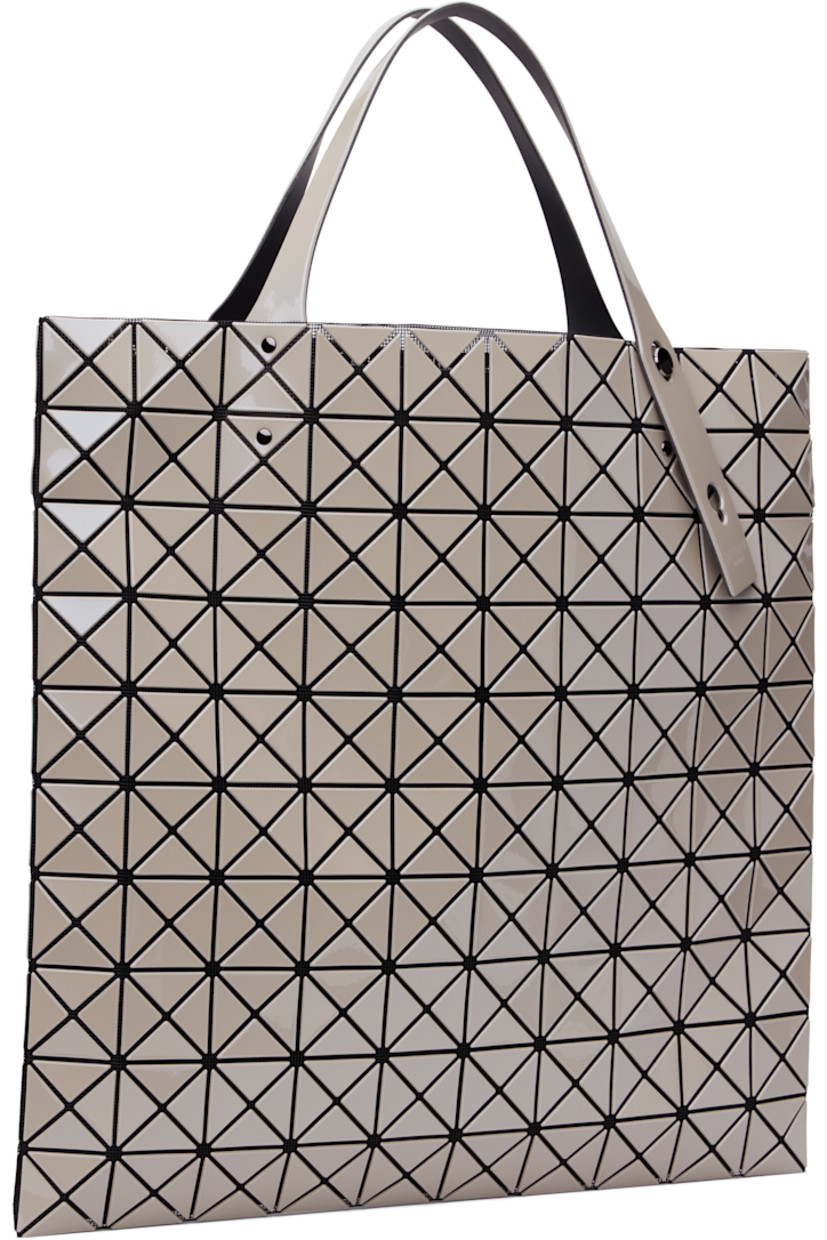 Mesh tote in black. Signature triangular vinyl appliqués in metallic gray throughout.

· Adjustable twin shoulder straps
· Open throat
· Zip pocket at interior
· Unlined 
· H15.5" x W15.5"

Supplier color: Greige