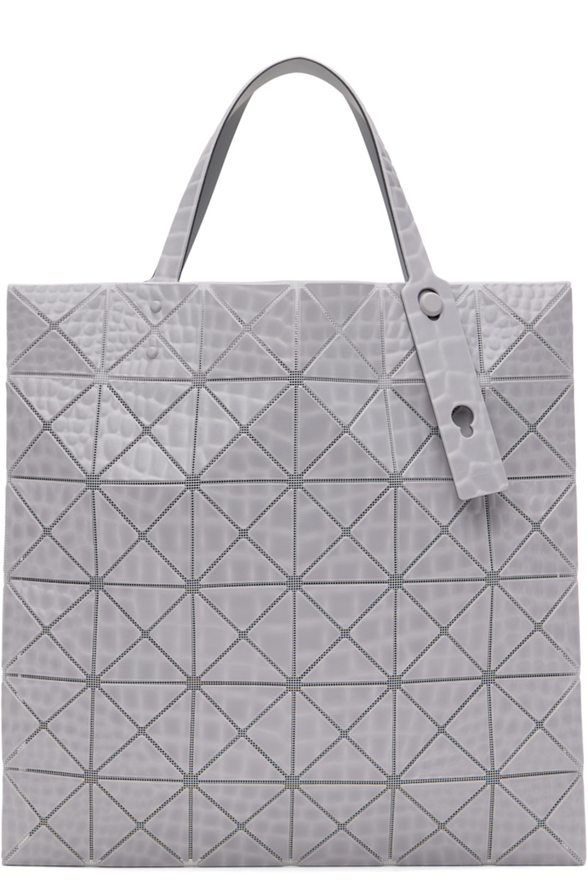 Mesh tote in gray.

· Croc-embossed signature triangular vinyl appliqués throughout
· Adjustable carry handles
· Open throat
· Zip pocket at interior
· H13.5" x W13.5"

Supplier color: Gray