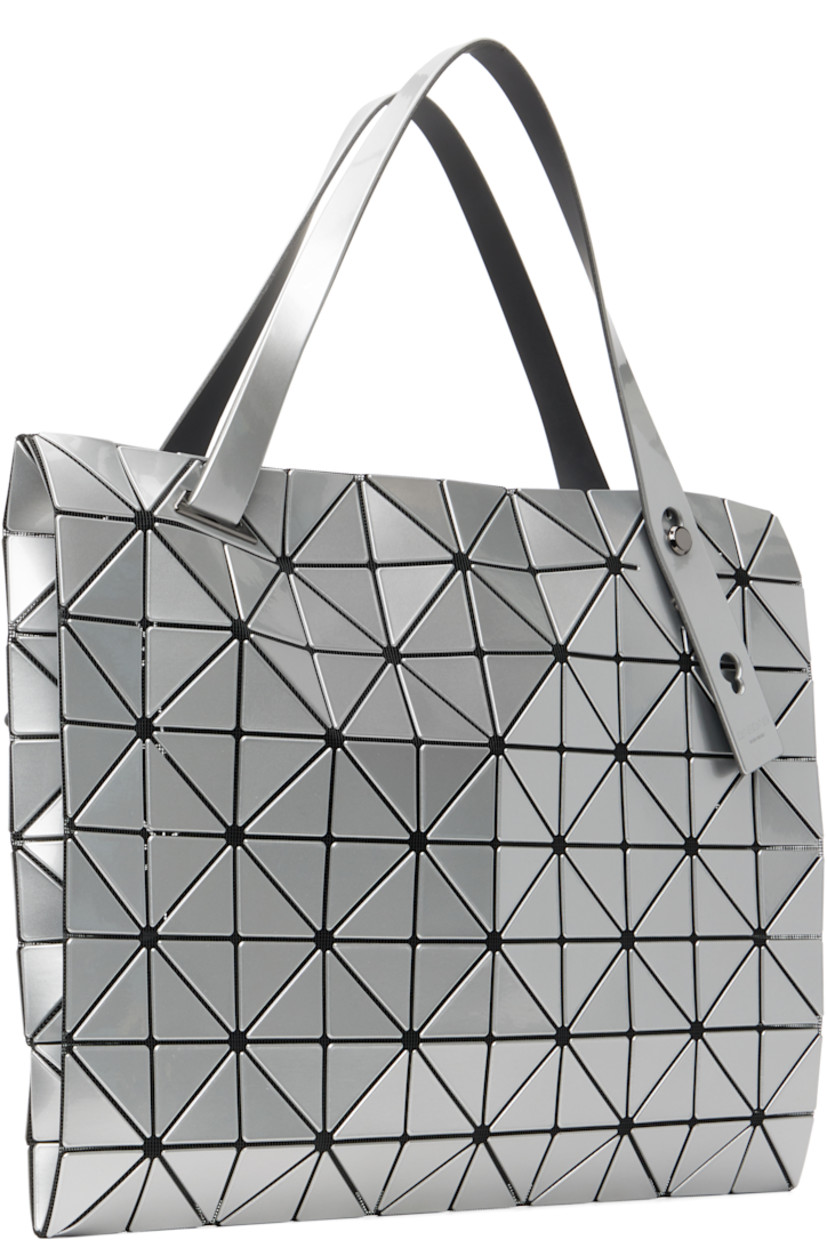 Mesh tote.

· Signature triangular vinyl appliqués in silver tone throughout
· Adjustable shoulder straps
· Two-way zip closure
· Zip pocket at interior
· H12.5" x W12.5"

Supplier color: Silver