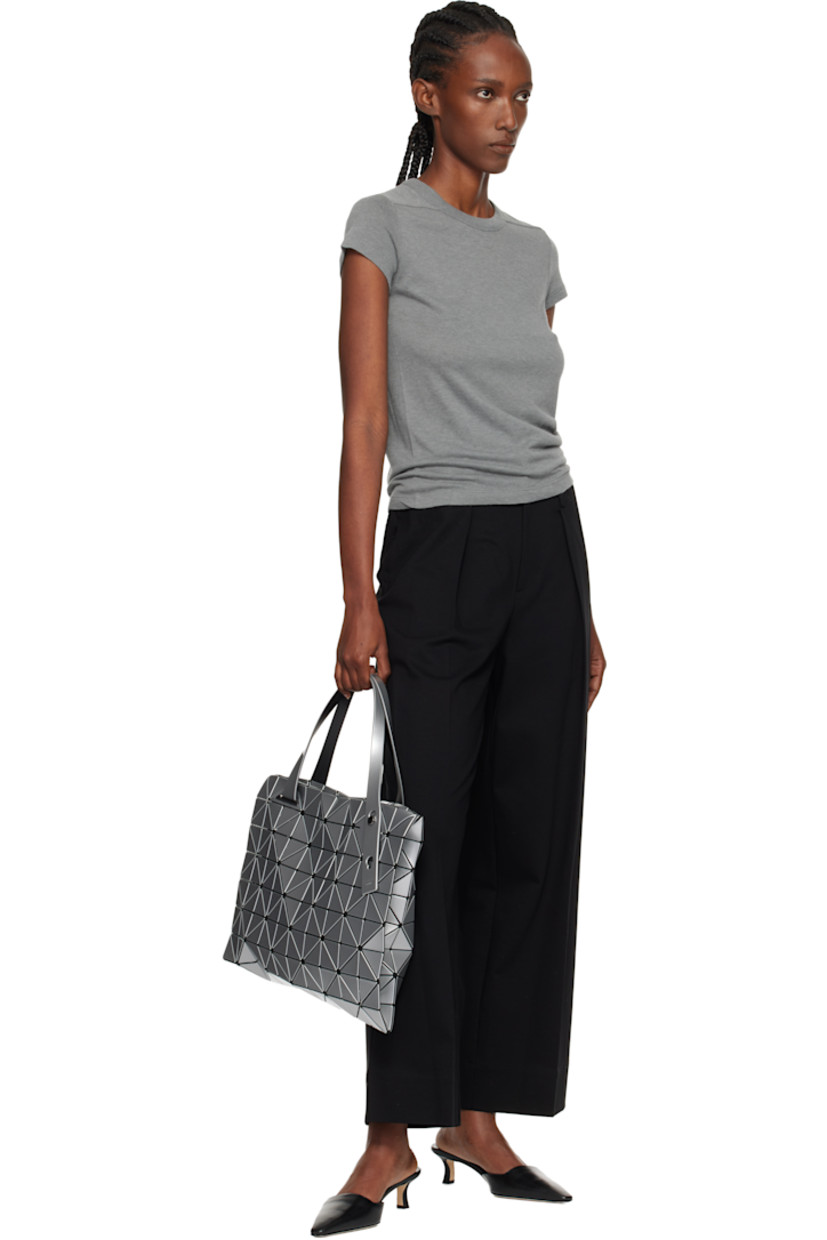 Mesh tote.

· Signature triangular vinyl appliqués in silver tone throughout
· Adjustable shoulder straps
· Two-way zip closure
· Zip pocket at interior
· H12.5" x W12.5"

Supplier color: Silver
