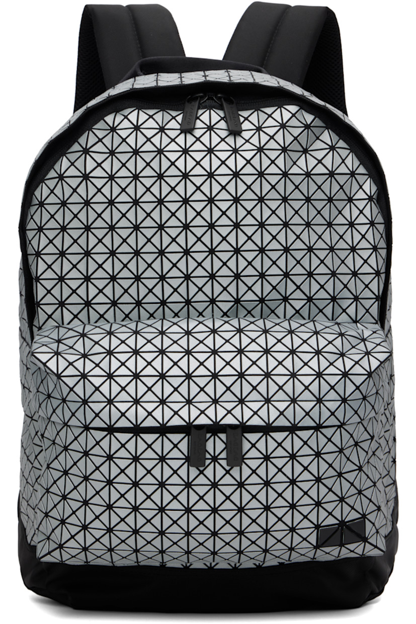 Canvas backpack. 

· Signature triangular coated appliqués in gray
· Carry handle
· Adjustable padded shoulder straps
· Zip compartment and logo appliqués at face
· Padded mesh back face
· Two-way zip closure
· Nylon twill lining
· H17" x W13.5" x D5"

Supplier color: Silver