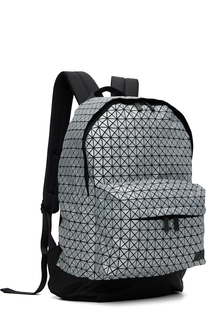 Canvas backpack. 

· Signature triangular coated appliqués in gray
· Carry handle
· Adjustable padded shoulder straps
· Zip compartment and logo appliqués at face
· Padded mesh back face
· Two-way zip closure
· Nylon twill lining
· H17" x W13.5" x D5"

Supplier color: Silver