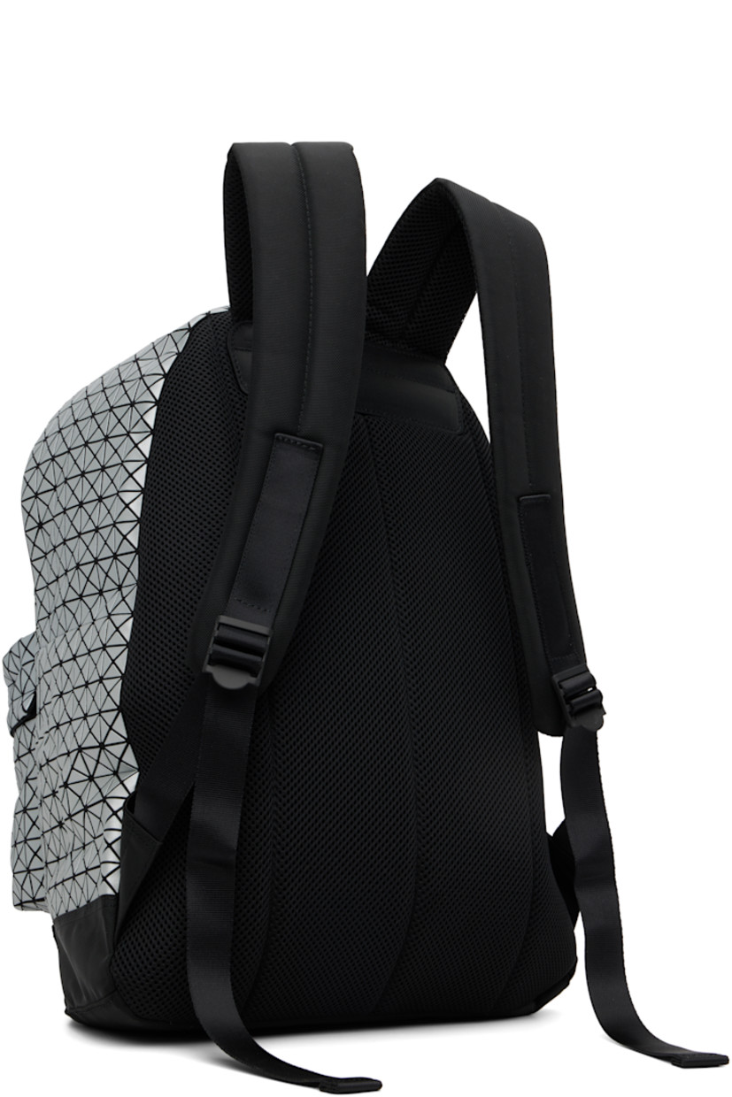 Canvas backpack. 

· Signature triangular coated appliqués in gray
· Carry handle
· Adjustable padded shoulder straps
· Zip compartment and logo appliqués at face
· Padded mesh back face
· Two-way zip closure
· Nylon twill lining
· H17" x W13.5" x D5"

Supplier color: Silver