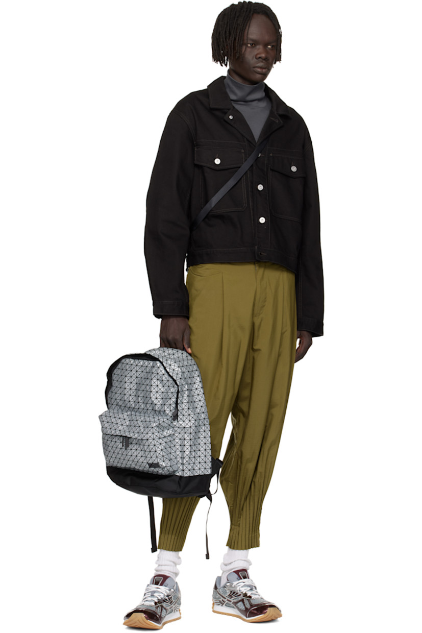 Canvas backpack. 

· Signature triangular coated appliqués in gray
· Carry handle
· Adjustable padded shoulder straps
· Zip compartment and logo appliqués at face
· Padded mesh back face
· Two-way zip closure
· Nylon twill lining
· H17" x W13.5" x D5"

Supplier color: Silver