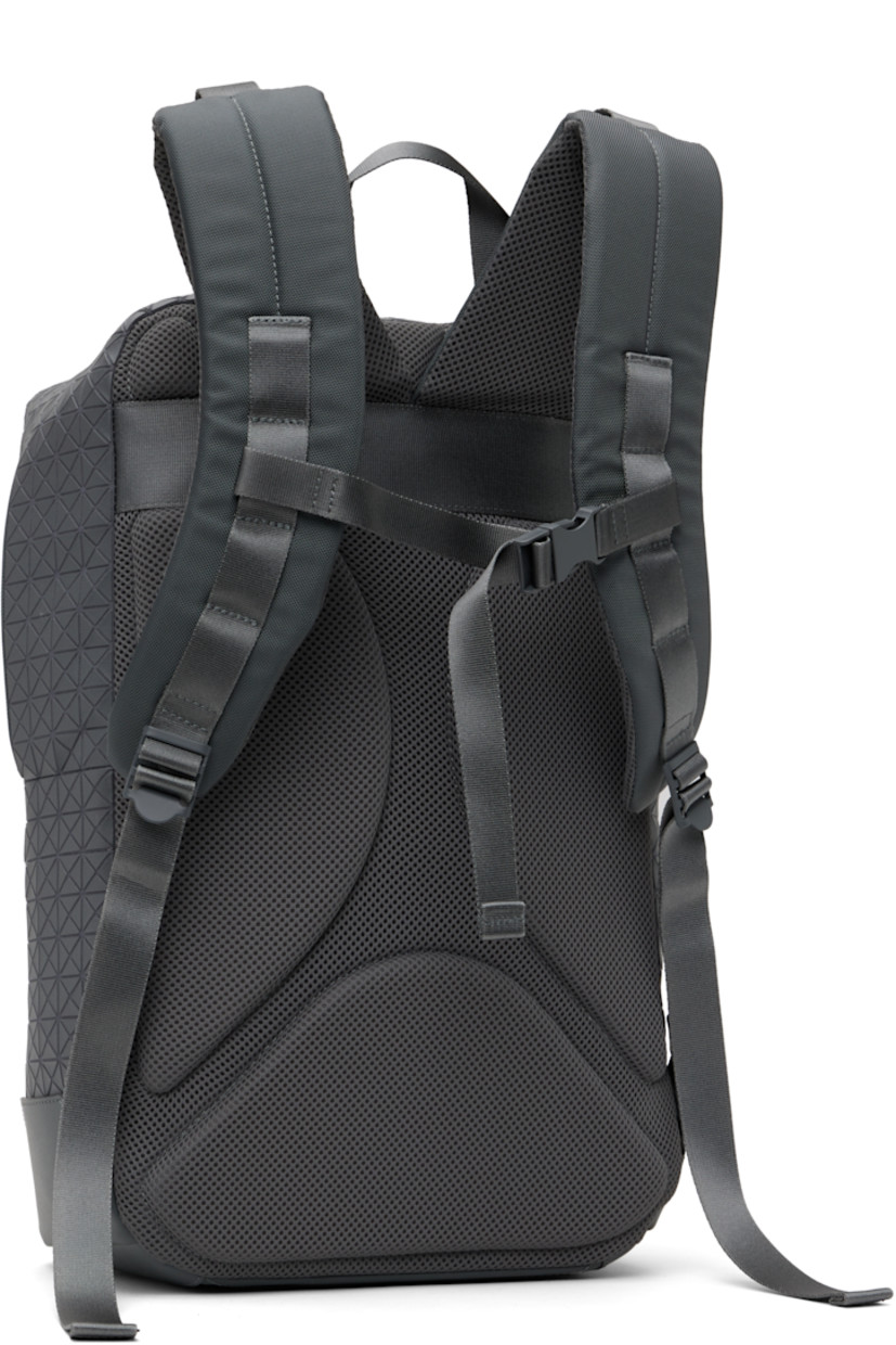 Cotton canvas backpack in gray. 

· Signature triangular vinyl appliqués throughout
· Rolled carry handle
· Adjustable padded shoulder straps
· Logo appliqué and zip pocket at face
· Padded mesh panel at back face
· Leather trim at base
· Two-way zip closure
· Zip pocket at interior
· Padded laptop compartment
· Nylon canvas lining
· H17" x W11" x D4"

Supplier color: One-tone gray