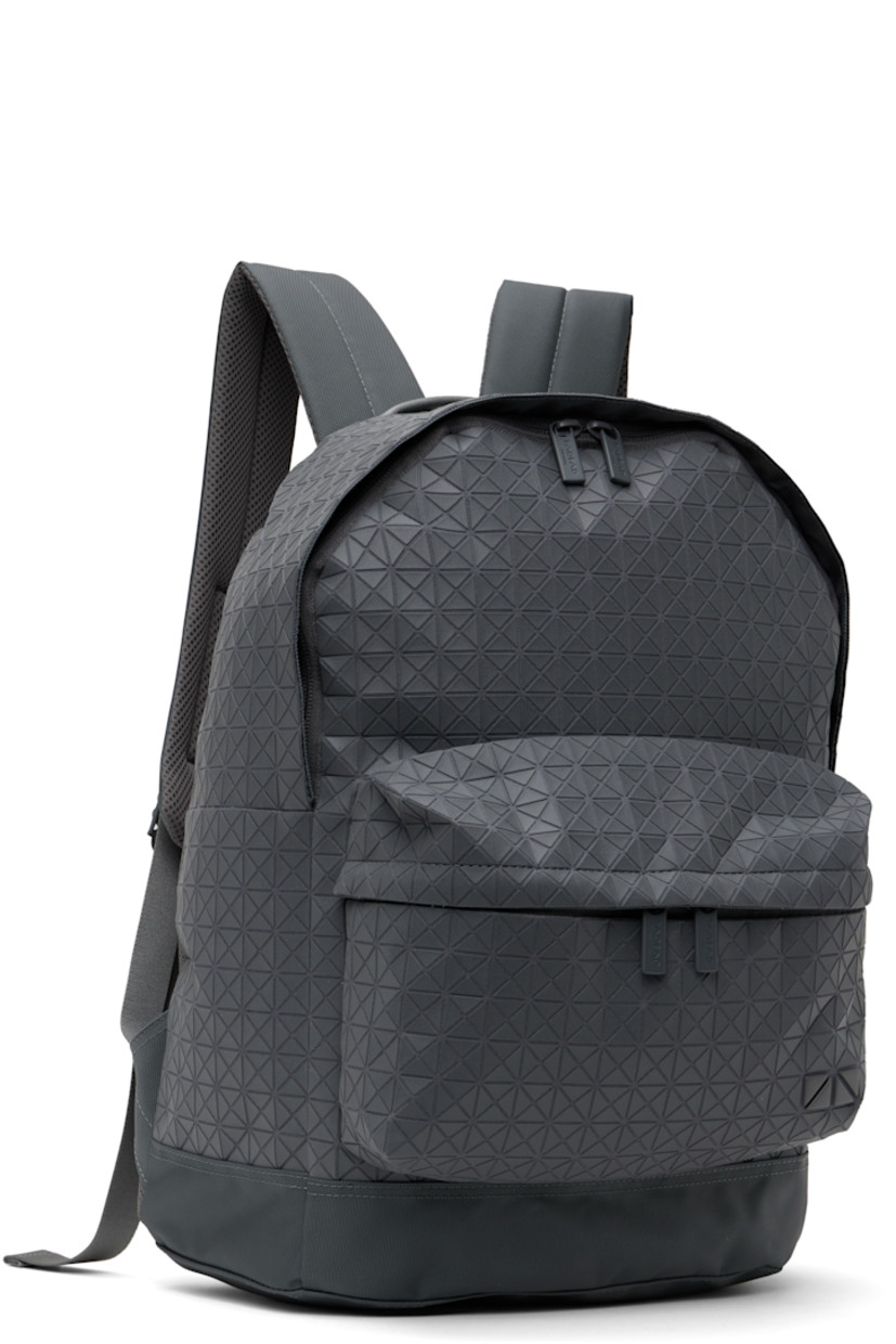 Cotton canvas backpack in gray.

· Signature triangular vinyl appliqués throughout
· Rolled carry handle
· Adjustable padded shoulder straps
· Zip compartment with logo appliqué at face
· Padded mesh panel and leather trim at back face
· Two-way zip closure
· Zip pocket and patch pockets at interior
· Canvas lining
· H17.25" x W13.23" x D5.75"

Supplier color: One-tone gray
