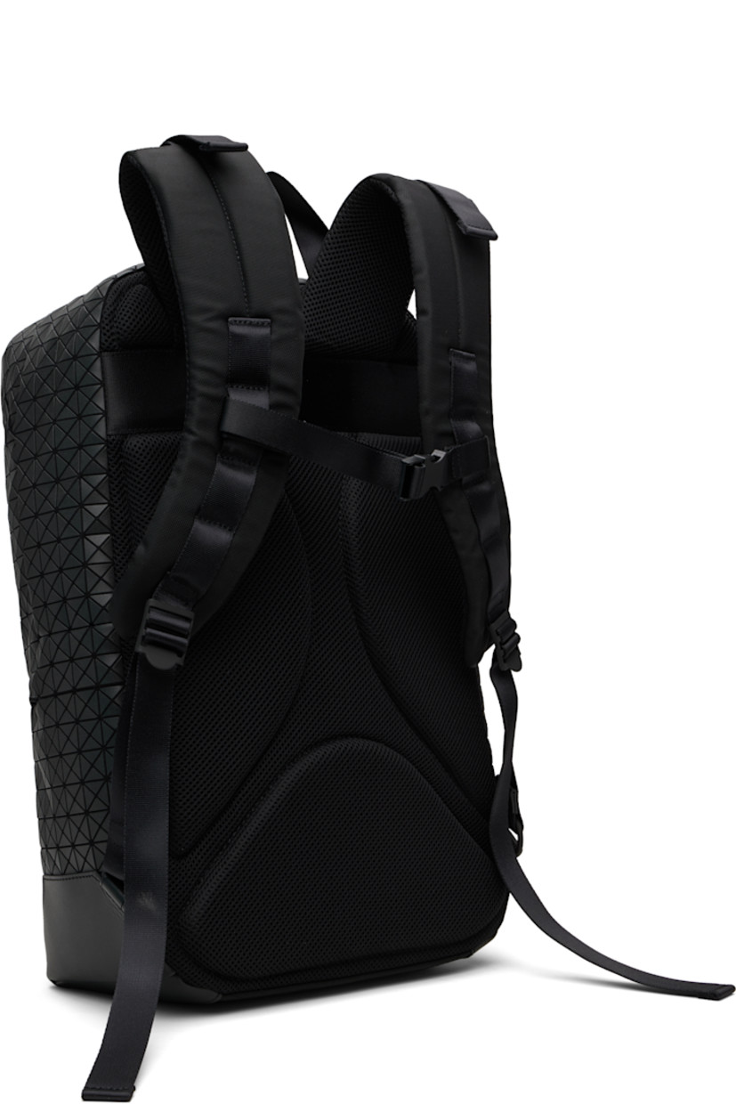 Canvas backpack.

· Signature triangular vinyl appliqués throughout
· Fixed carry handle
· Adjustable padded shoulder straps
· Zip pocket at face
· Padded mesh panel at back face
· Two-way zip closure
· Zip pocket at interior
· Padded laptop compartment
· Canvas lining
· H17" x W11" x D4"

Supplier color: Matte black