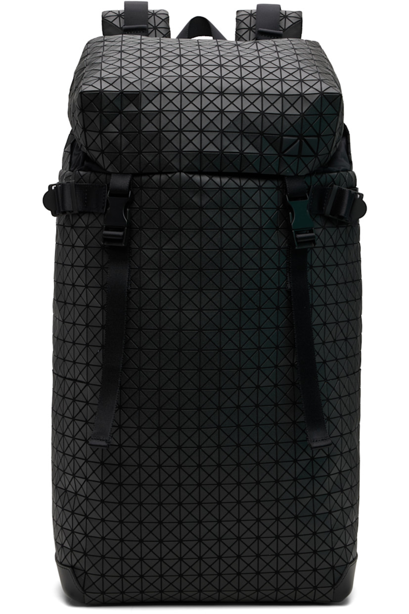 Canvas backpack.

· Signature triangular vinyl appliqués throughout
· Fixed carry handle
· Adjustable padded shoulder straps
· D-ring and daisy chain at straps
· Press-release sternum strap
· Zip pocket at top
· Cinch tab at sides
· Zip opening at padded mesh back face
· Press-release flap
· Bungee-style drawstring closure
· Zip pocket at interior
· Padded laptop compartment
· H20" x W13" x D5"

Supplier color: Matte black