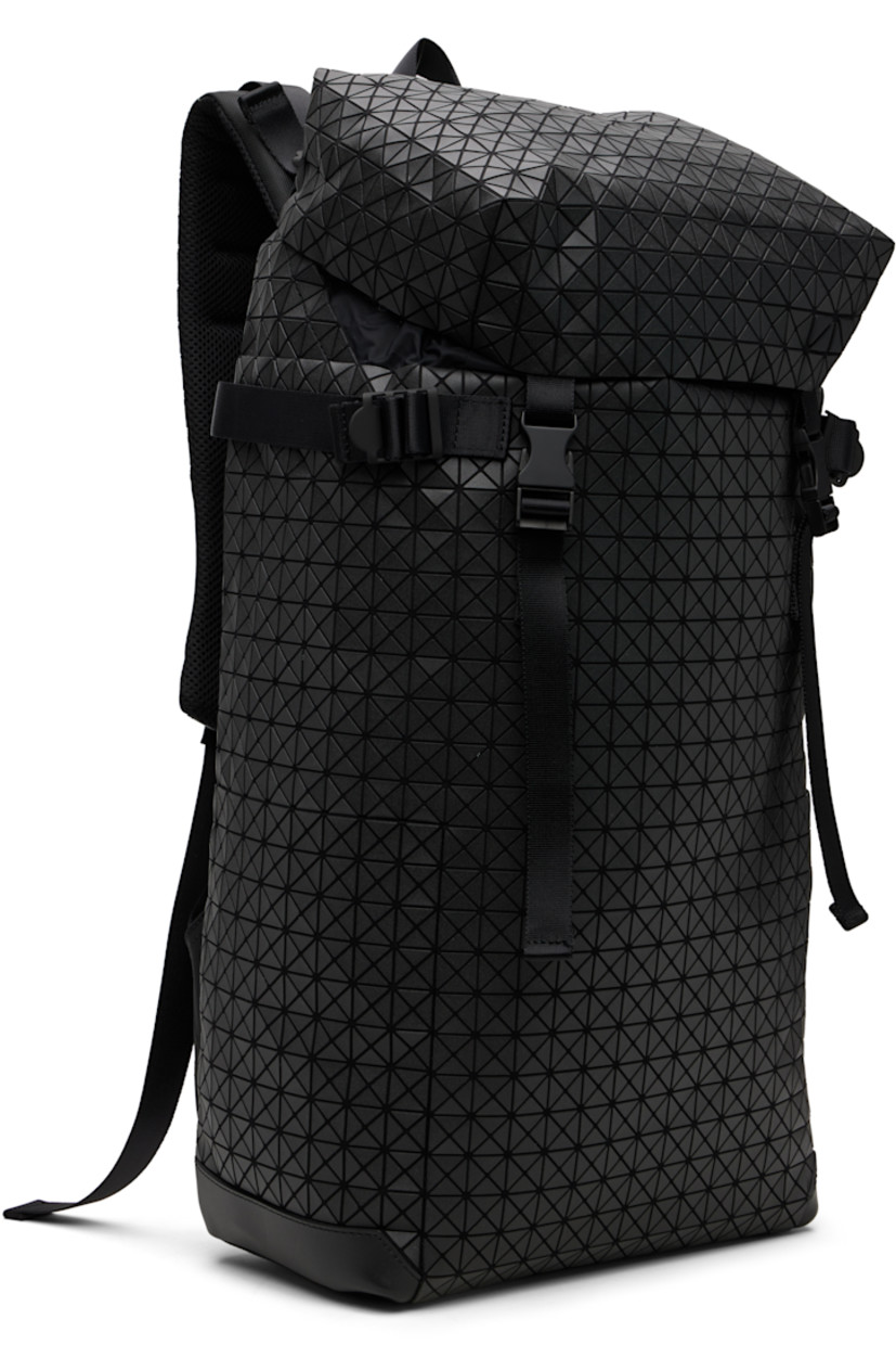 Canvas backpack.

· Signature triangular vinyl appliqués throughout
· Fixed carry handle
· Adjustable padded shoulder straps
· D-ring and daisy chain at straps
· Press-release sternum strap
· Zip pocket at top
· Cinch tab at sides
· Zip opening at padded mesh back face
· Press-release flap
· Bungee-style drawstring closure
· Zip pocket at interior
· Padded laptop compartment
· H20" x W13" x D5"

Supplier color: Matte black