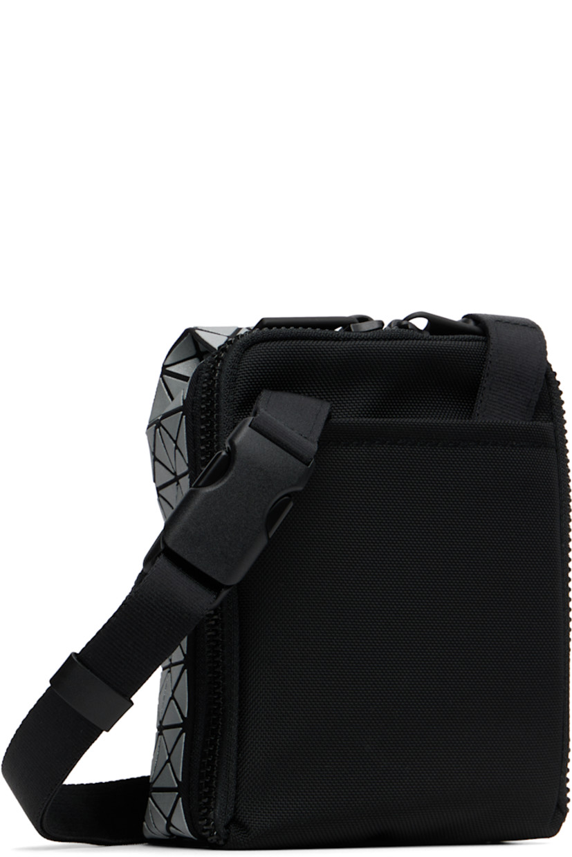 Twill messenger bag.

· Triangular reflective vinyl appliqués throughout
· Adjustable and detachable crossbody strap
· Patch pocket at back face
· Two-way zip closure
· Clasp at two-compartment interior
· Zip pocket and three card slots
· H6" x W5" x D2"

Supplier color: Silver