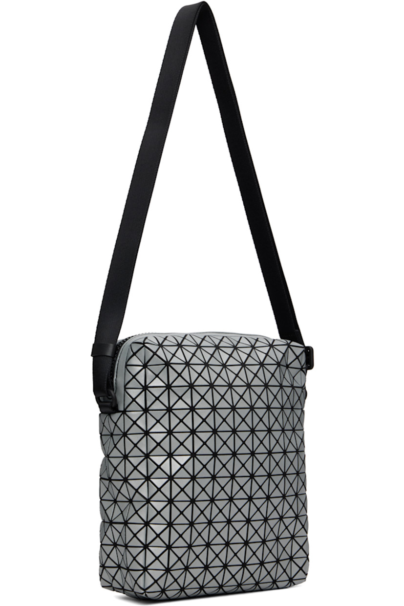Twill messenger bag.

· Triangular reflective vinyl appliqués throughout
· Adjustable crossbody strap
· Patch pocket at face
· Zip closure
· Patch pocket at interior
· H9" x W8" x D2.5"

Supplier color: Silver