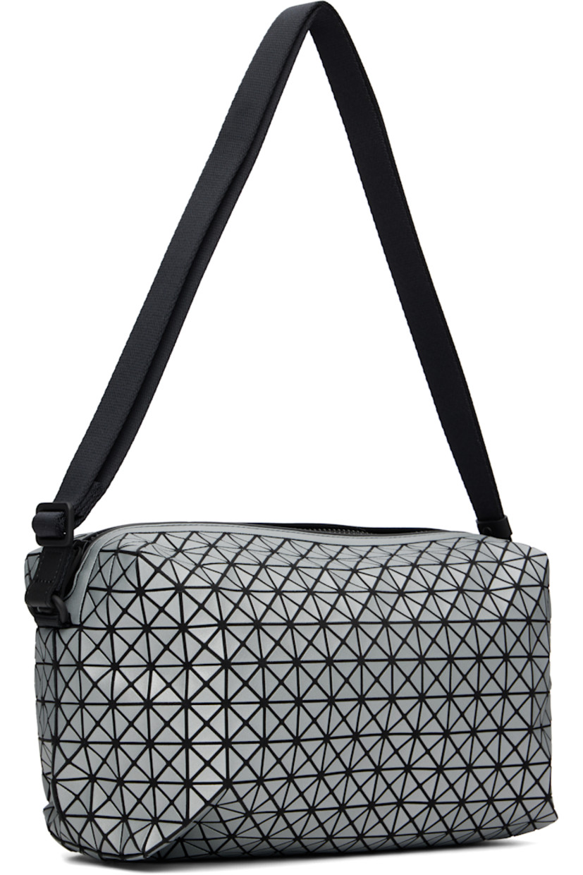 Twill messenger bag.

· Triangular reflective vinyl appliqués throughout
· Adjustable crossbody strap
· Zip closure
· Zip pocket at interior
· H5.5" x W11" x D6"

Supplier color: Silver