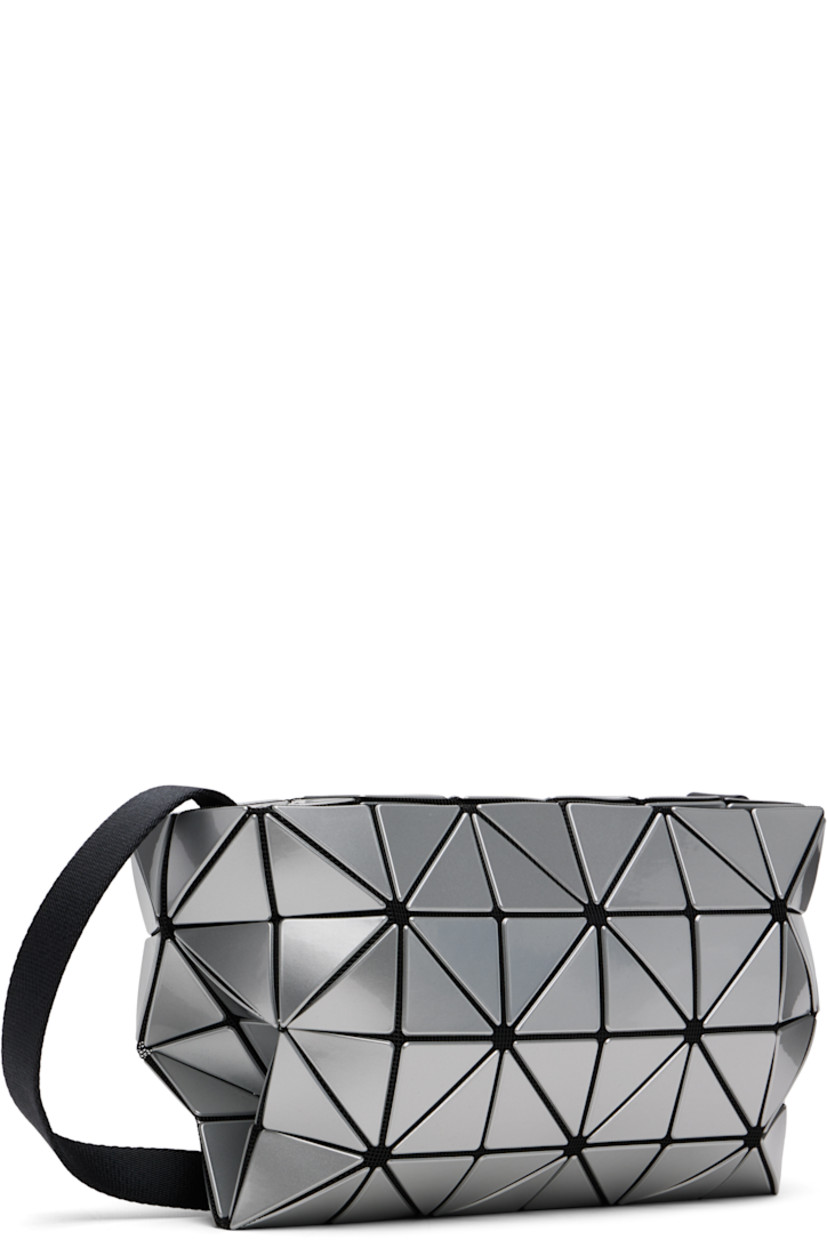 Mesh messenger bag.

· Signature triangular vinyl appliqués in silver tone throughout
· Adjustable crossbody strap
· Zip closure
· Zip pocket at interior
· Logo-woven canvas lining
· H7" x W8" x D3"

Supplier color: Silver