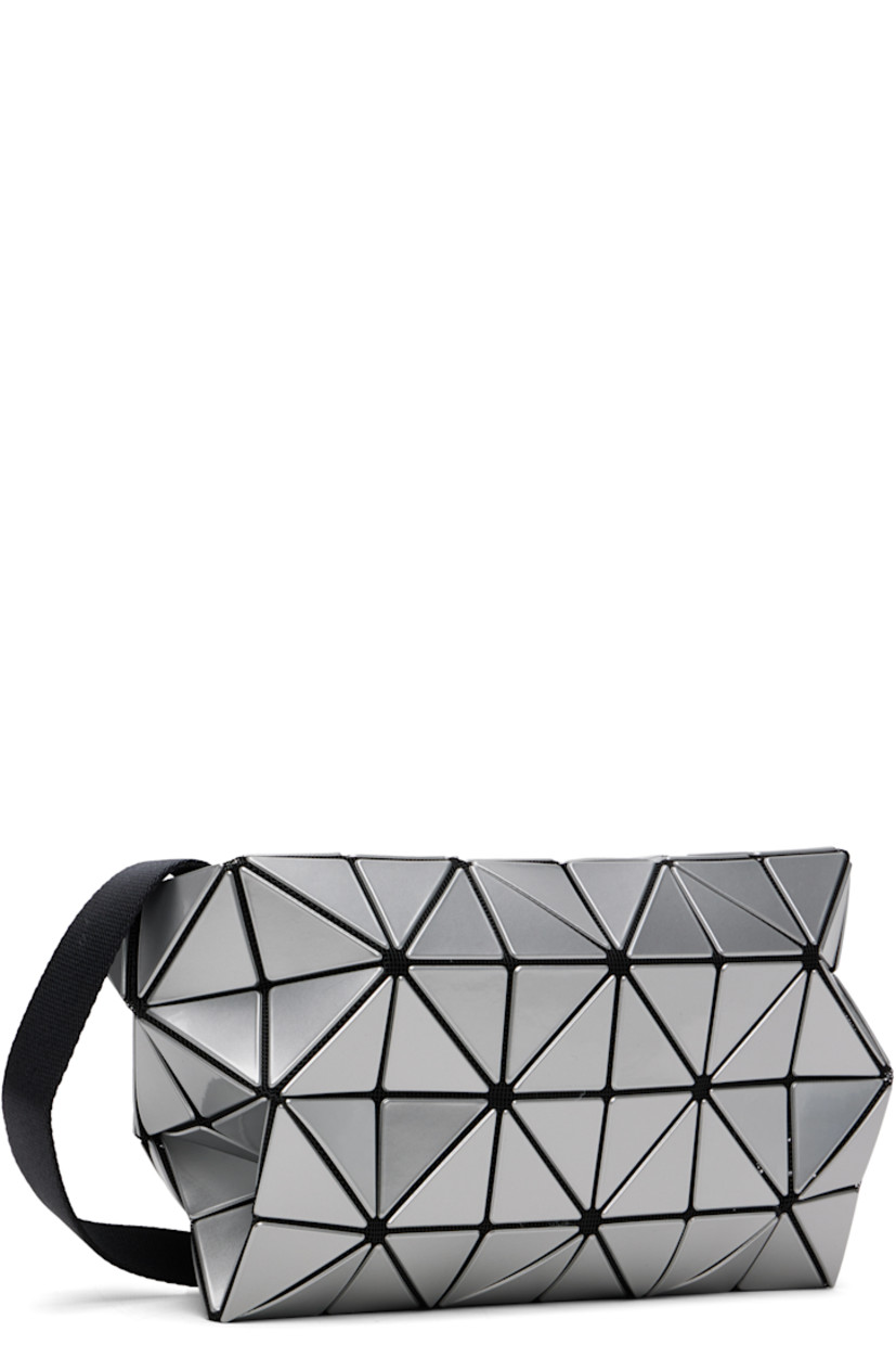 Mesh messenger bag.

· Signature triangular vinyl appliqués in silver tone throughout
· Adjustable crossbody strap
· Zip closure
· Zip pocket at interior
· Logo-woven canvas lining
· H7" x W8" x D3"

Supplier color: Silver