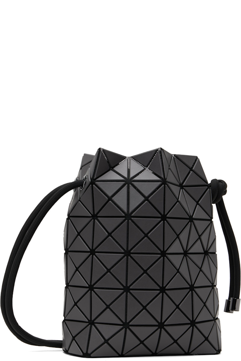 Mesh messenger bag in black. 

· Triangular faux-leather appliqués in gray throughout
· Adjustable drawstring shoulder strap
· Open throat
· Zip pocket at interior
· Patterned textile lining
· H9" x W8" x D3.5"

Supplier color: Charcoal