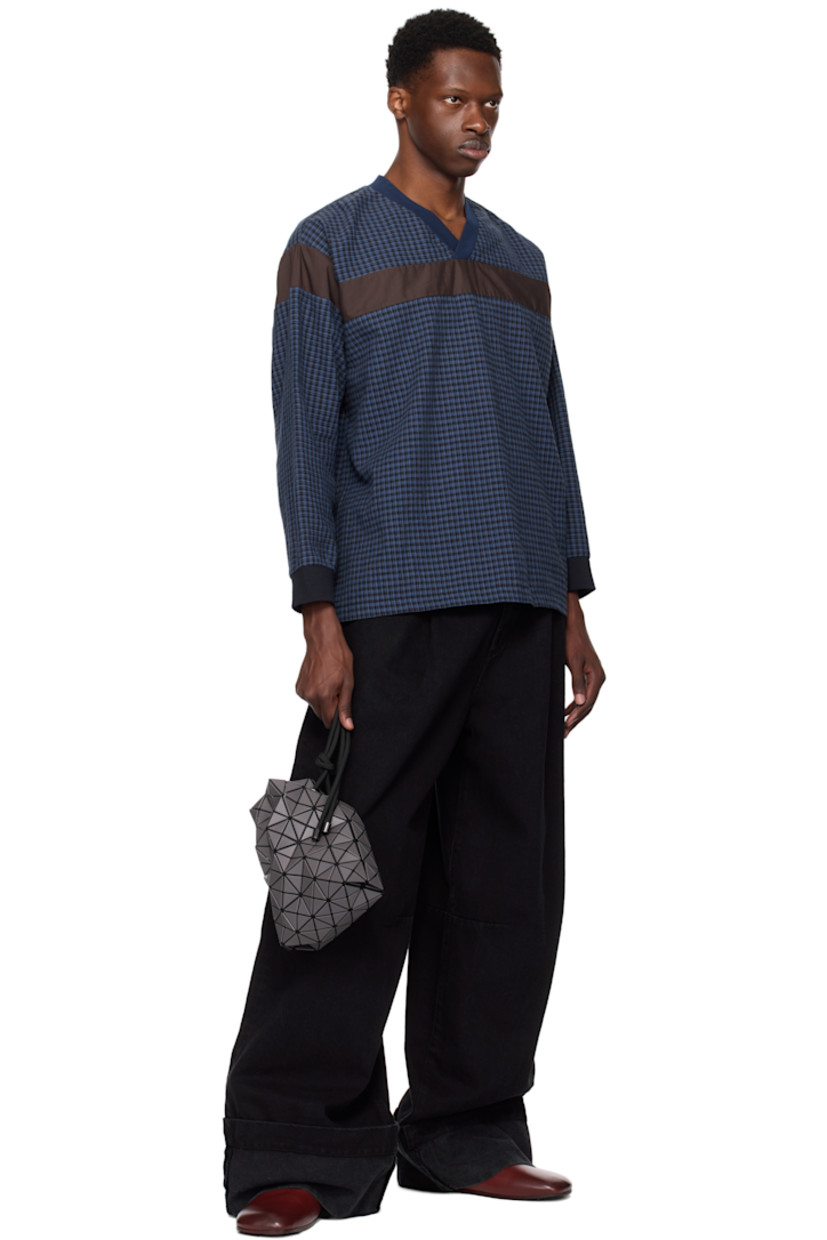 Mesh messenger bag in black. 

· Triangular faux-leather appliqués in gray throughout
· Adjustable drawstring shoulder strap
· Open throat
· Zip pocket at interior
· Patterned textile lining
· H9" x W8" x D3.5"

Supplier color: Charcoal
