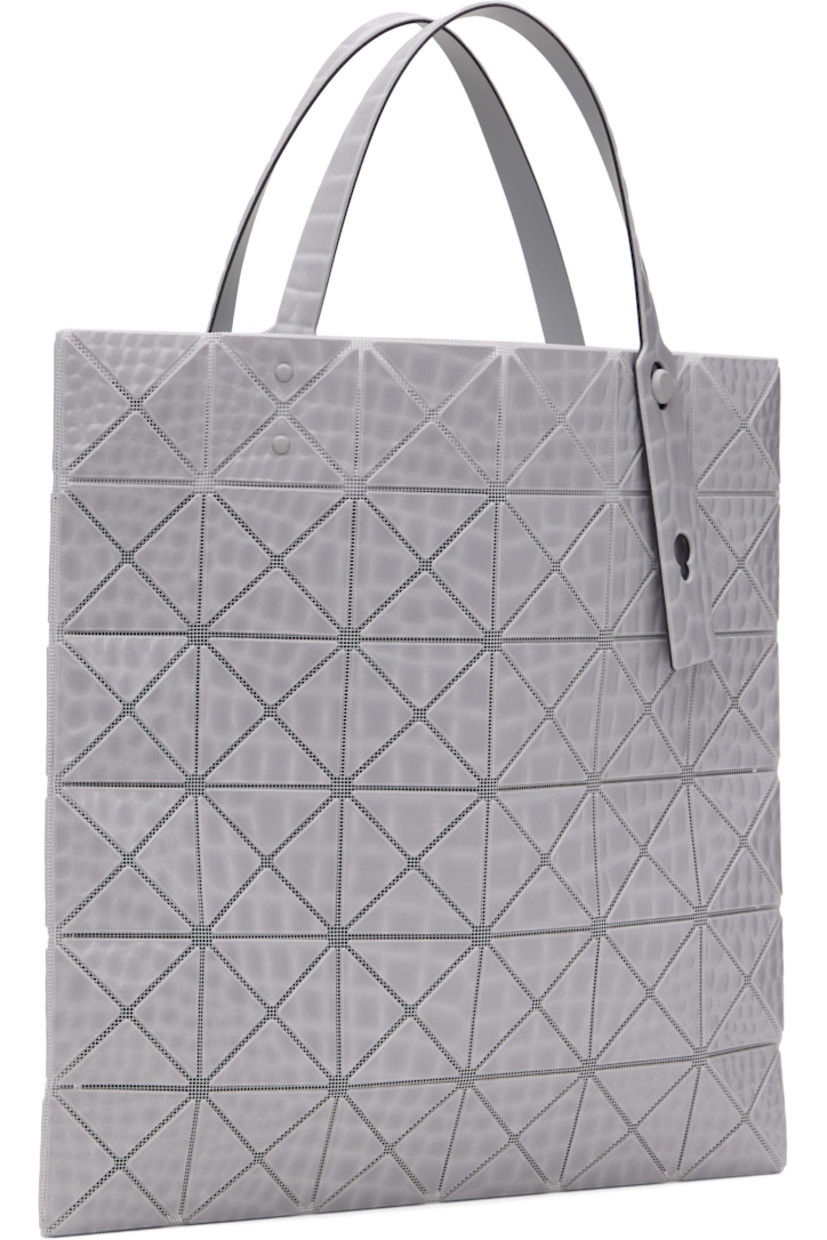 Mesh tote in gray.

· Croc-embossed signature triangular vinyl appliqués throughout
· Adjustable carry handles
· Open throat
· Zip pocket at interior
· H13.5" x W13.5"

Supplier color: Gray