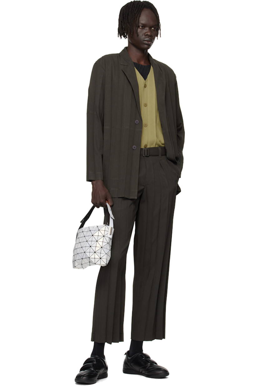 Mesh shoulder bag. 

· Signature triangular vinyl appliqués in white
· Adjustable shoulder strap
· Zip closure
· Logo-woven zip pocket at interior
· Unlined
· Logo-engraved gunmetal-tone hardware
· H7.5" x W11" x D2"

Supplier color: Pearl white