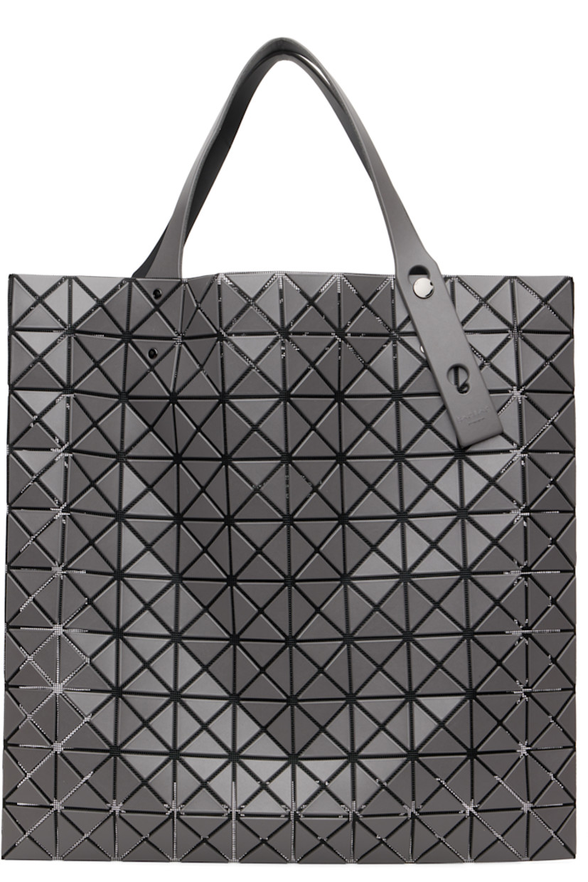 Mesh tote.

· Signature triangular vinyl appliqués in gray throughout
· Adjustable shoulder straps
· Open throat
· Zip pocket at interior
· H15" x W15"

Supplier color: Charcoal gray