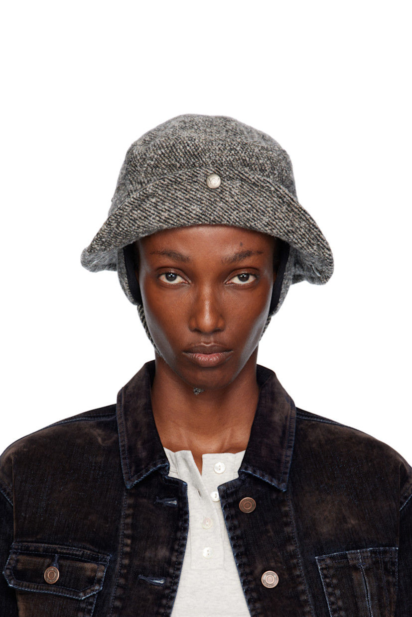 Stretch wool tweed bucket hat.

· Logo embroidered at face
· Press-stud fastening at sides and back
· Pliable wire at brim
· Detachable ear flaps with press-stud chin strap
· Satin twill lining
· Logo-engraved antiqued silver-tone hardware

Supplier color: Charcoal