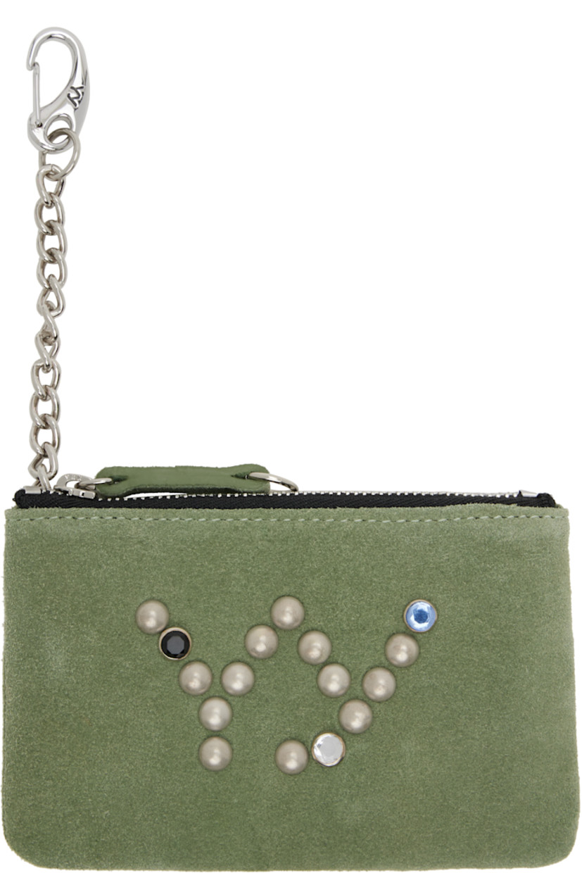 Suede wallet. 

· Studded logo with crystal-cut accents at face 
· Logo-embossed loop at back face 
· Zip closure
· Integrated curb chain lanyard clasp
· Twill lining
· H3.5" x W5.25" x D0.5"

Supplier color: Olive