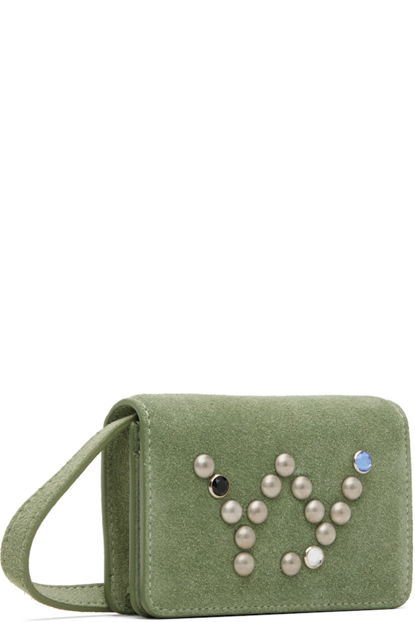 Suede shoulder bag.

· Detachable and adjustable crossbody strap
· Studded logo at face
· Embossed logo at back face
· Press-stud flap
· Three card slots at interior
· Gunmetal-tone and crystal-cut hardware
· H3" x W4" x D1.25"

Supplier color: Olive