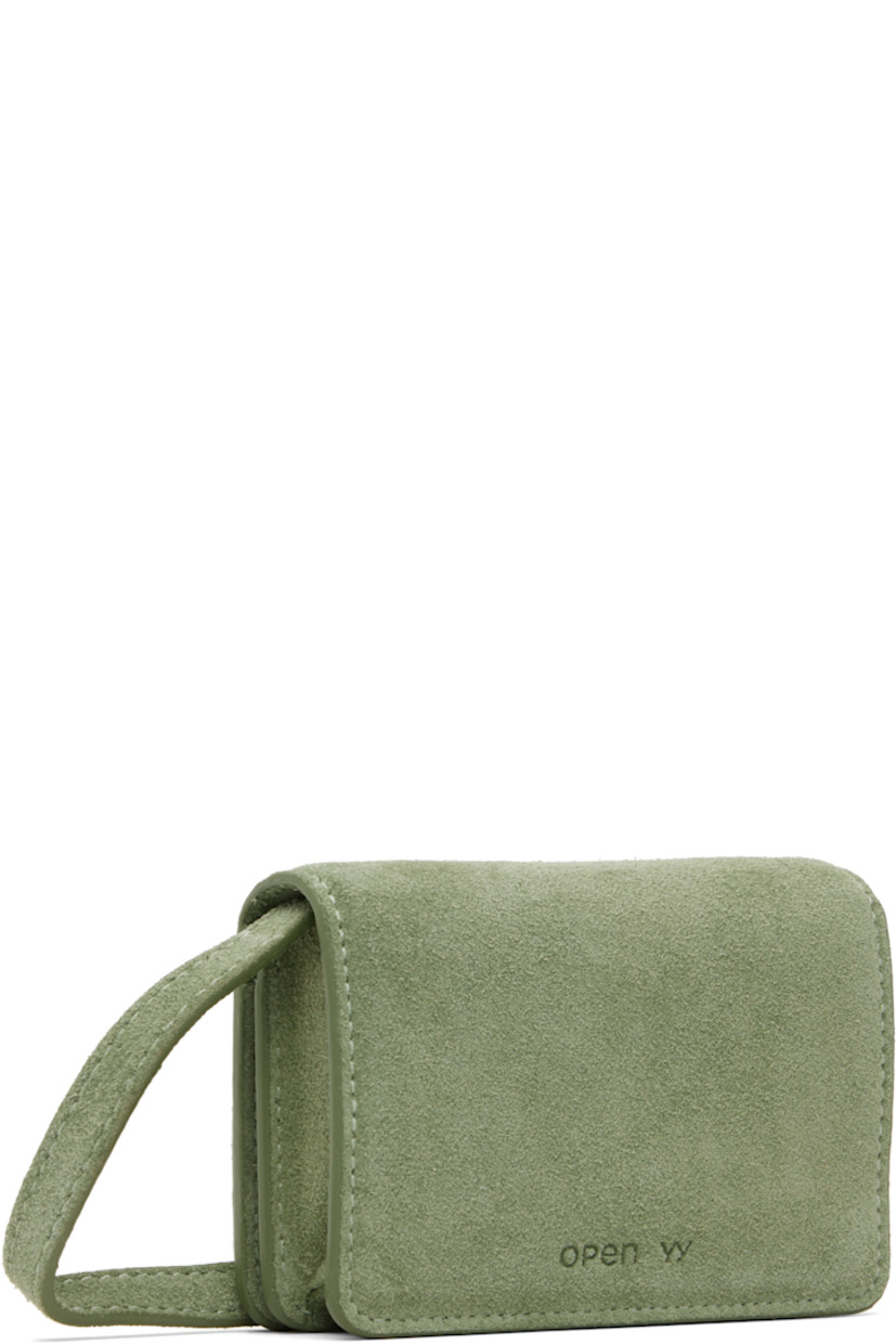 Suede shoulder bag.

· Detachable and adjustable crossbody strap
· Studded logo at face
· Embossed logo at back face
· Press-stud flap
· Three card slots at interior
· Gunmetal-tone and crystal-cut hardware
· H3" x W4" x D1.25"

Supplier color: Olive